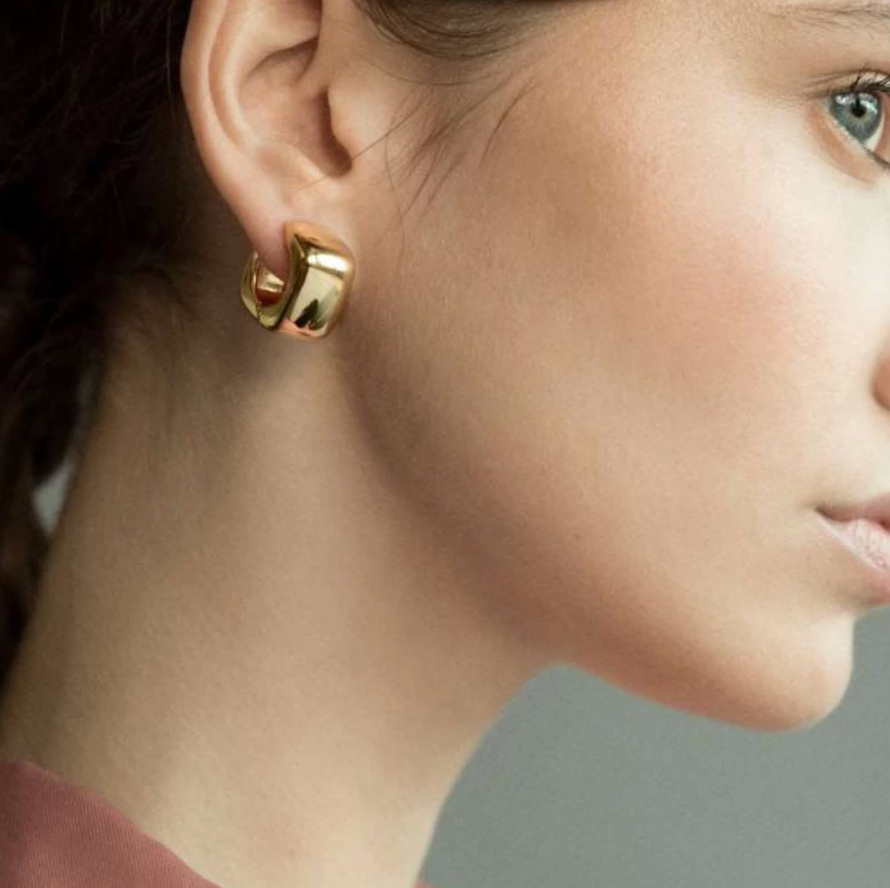 Gold Geo Square Earrings being worn by a woman with dark hair.