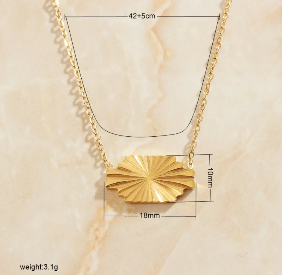 A Gold Horizontal Sunburst Pendant Necklace presented on a marbled background showing measurements in black text.