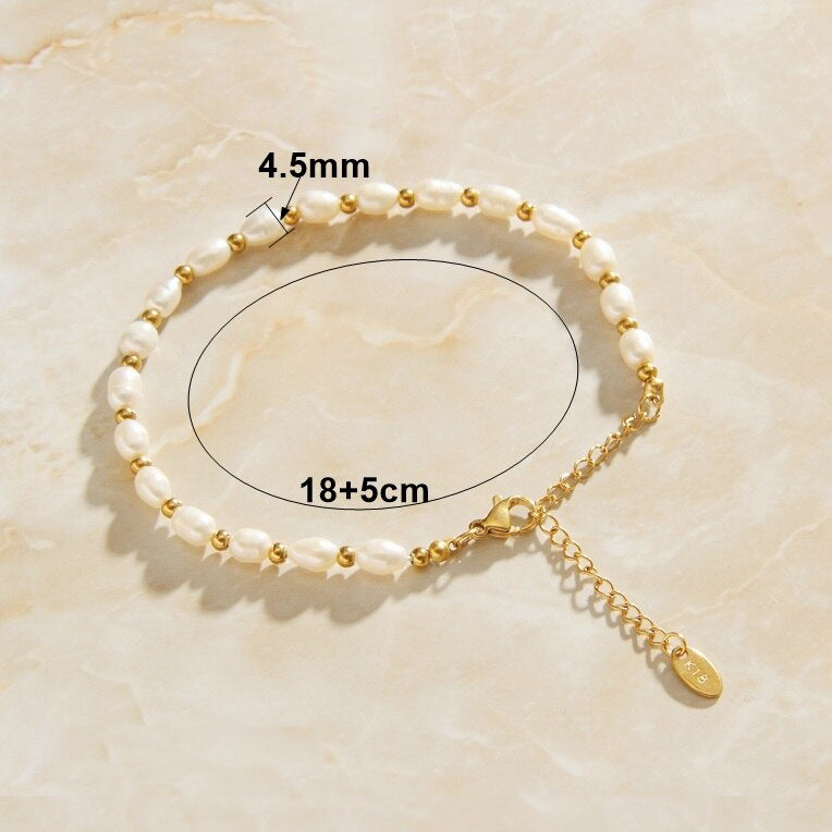 Gold Pearl Chain Link Bracelet on a smooth surface showing the dimensions of the piece in millimetres.