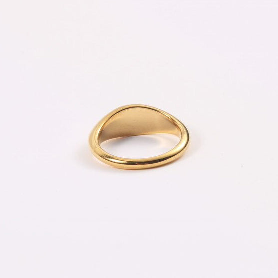 Gold Small Oval Signet Ring on a white surface.