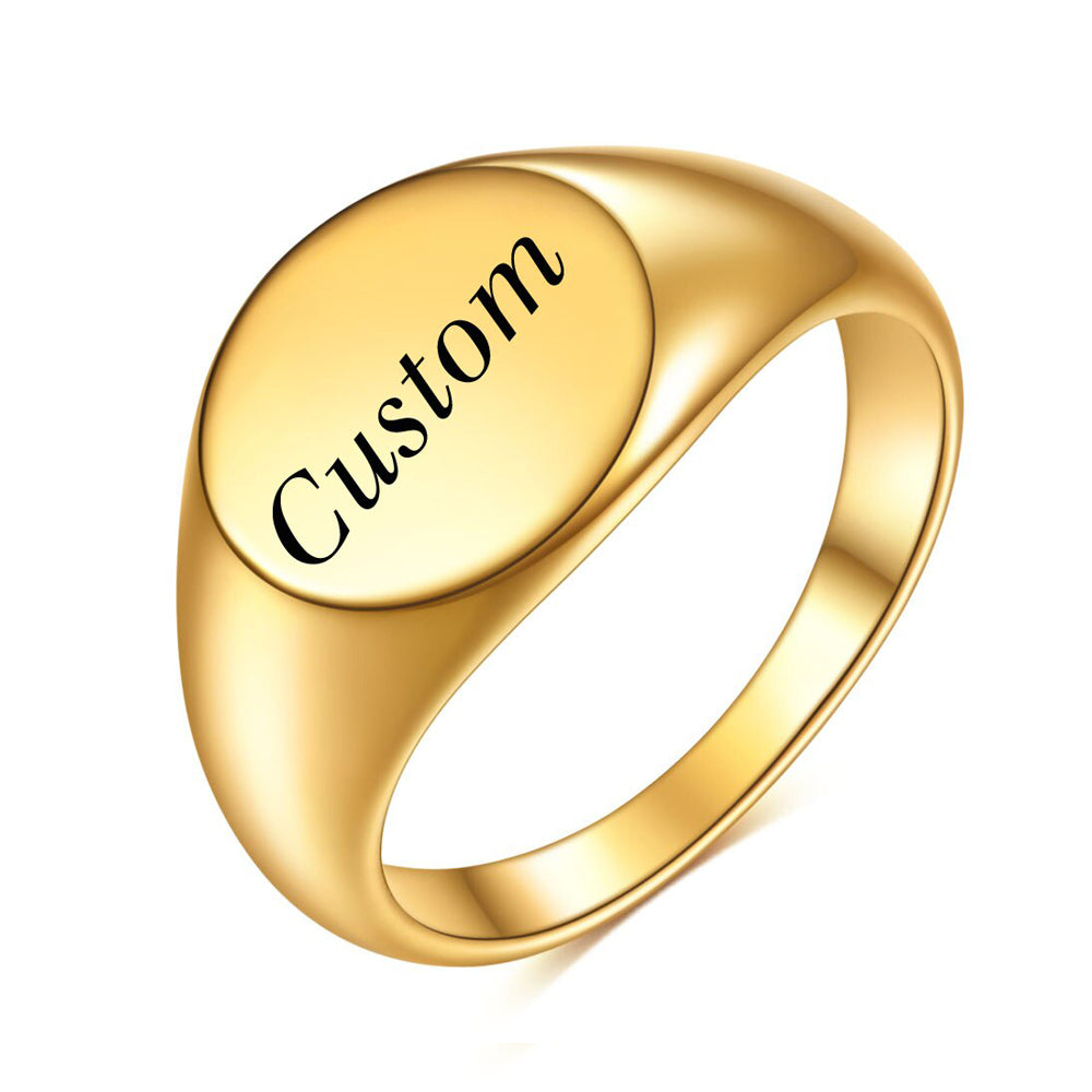A custom gold signet ring with a round face perfect for custom engravings.