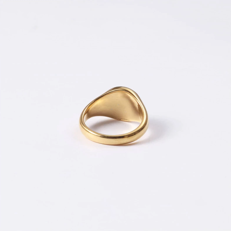 A gold ring with a unique curved shape, perfect for adding a touch of elegance to any outfit.