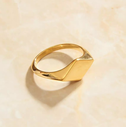 A diamond-shaped gold signet ring, showcasing elegance and sophistication.