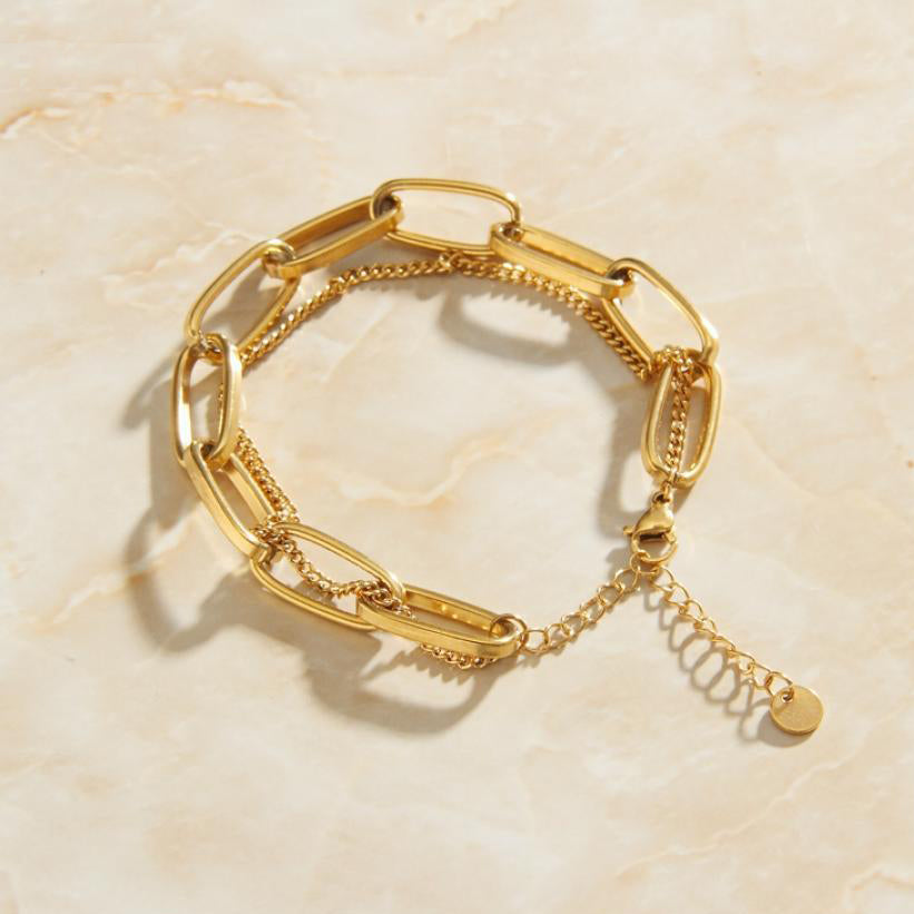 Gold Double Layer Chain Link Bracelet on smooth marble background.