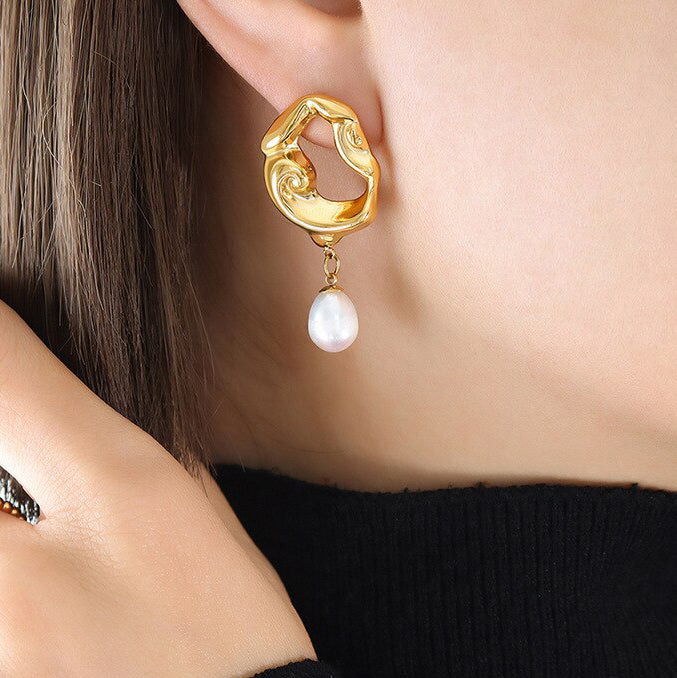 Gold Drop Earrings with Freshwater Pearls being worn by a woman with brunette hair.