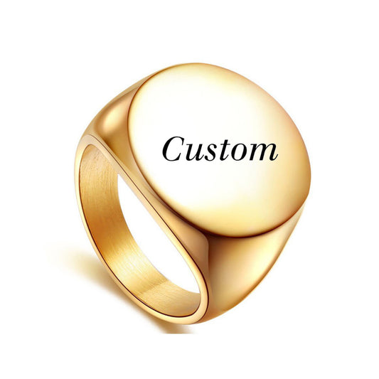 A custom gold signet ring with a large round face perfect for custom engravings.