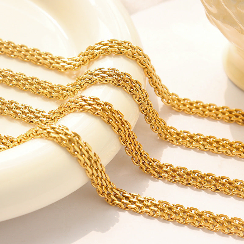 Four Gold Multi Layer Chain Link Bracelets on a white presentation dish.