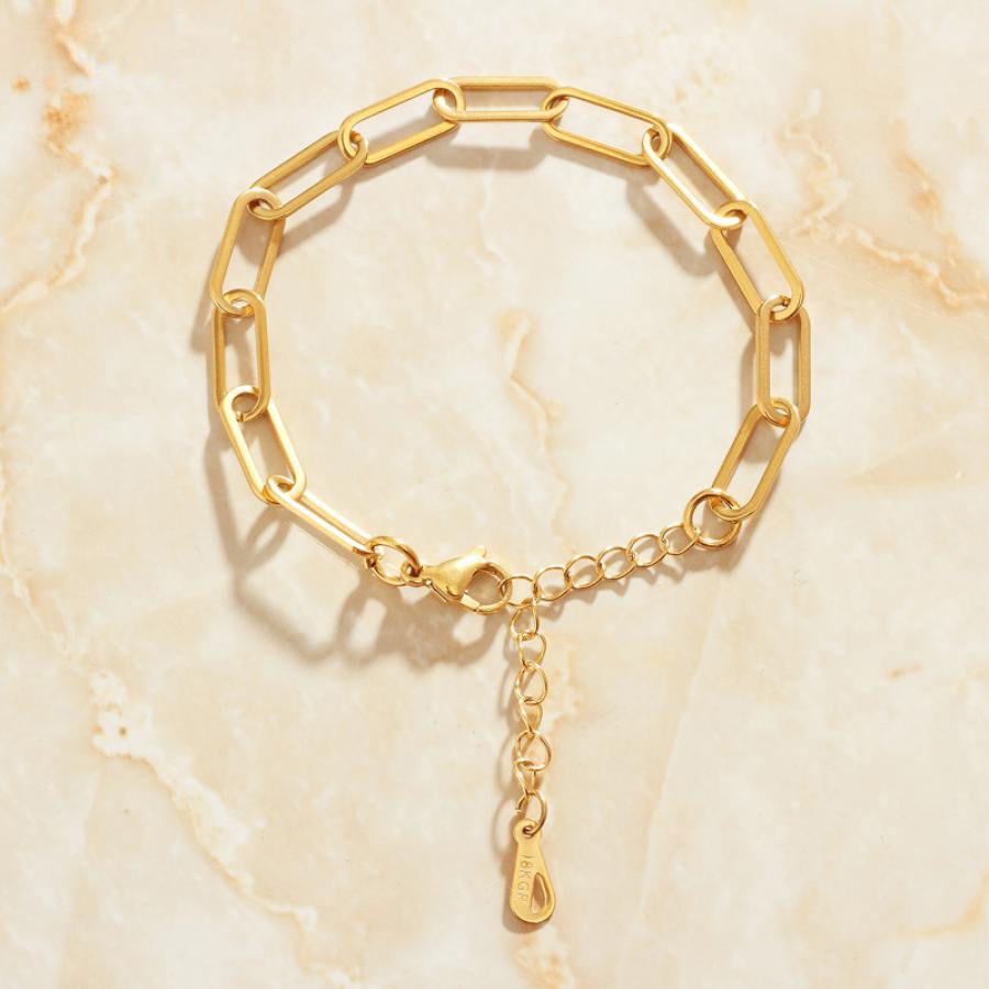 Gold Long Link Bracelet on marble background.