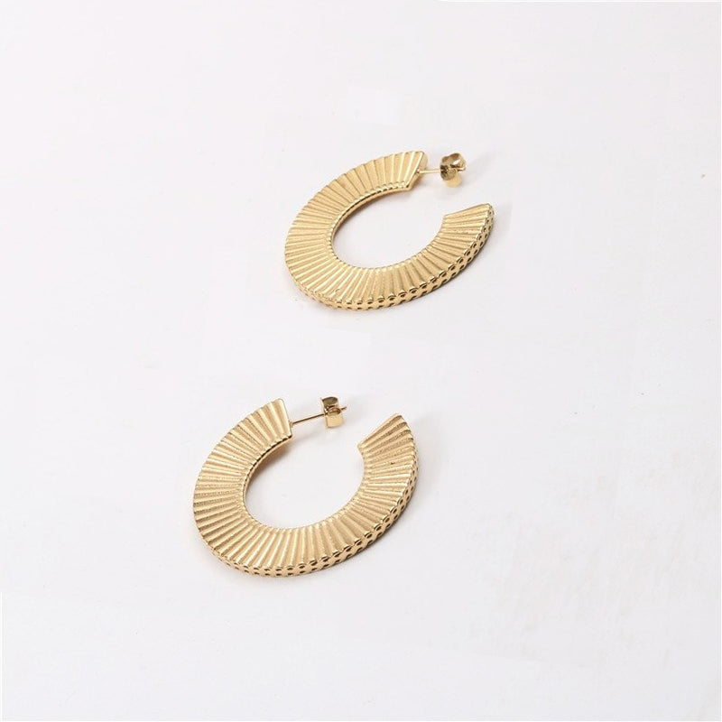 Gold Ribbed Curved Earrings on a plain white background.