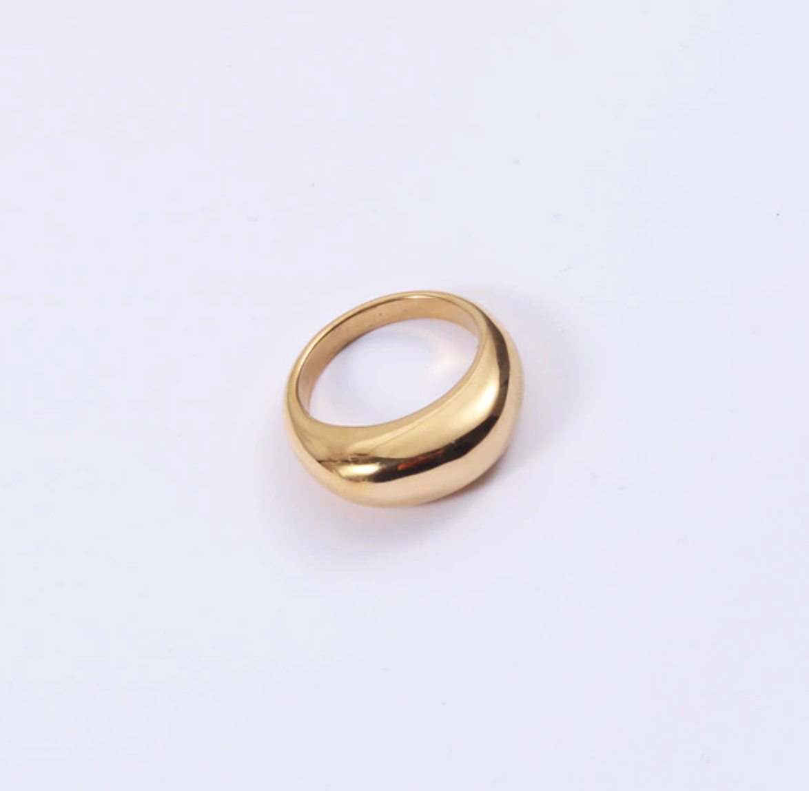 A smooth gold signet ring on a plain white background.