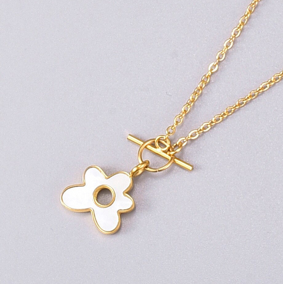A Flower Pendant on simple chain with T-bar link on alight grey background.