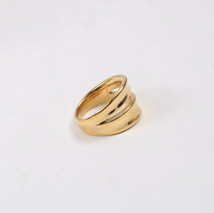 A Gold Twin Split Signet Ring shining brightly on a white background.