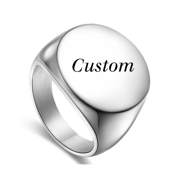 A custom silver signet ring with a round face perfect for custom engravings.